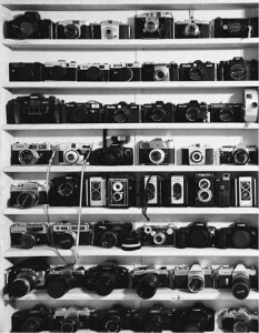 old cameras on shelf, black and white of old cameras, cameras on shelf